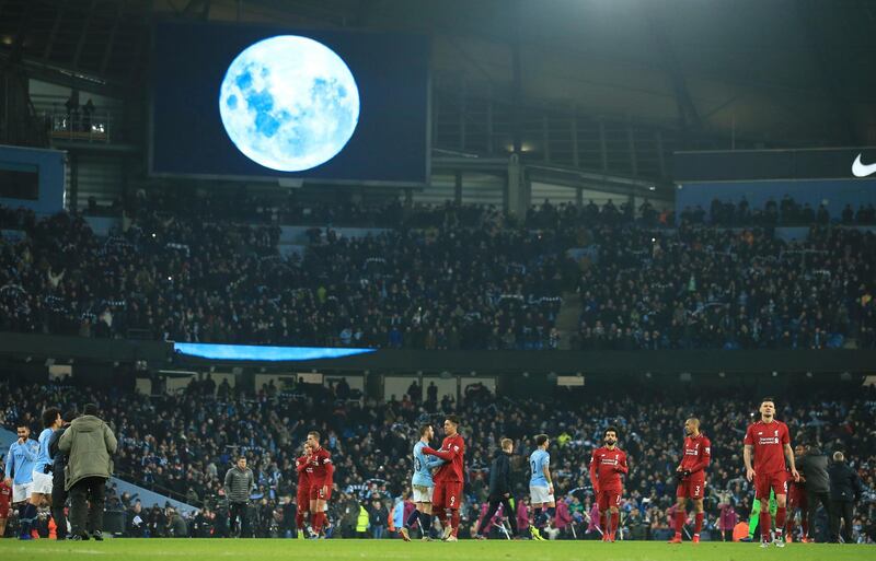 A large 'Blue Moon' image is shown on the large screen after Manchester City defeated Liverpool in their English Premier League soccer match. AP