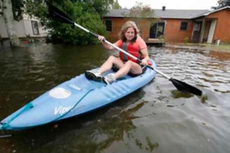 Ruth Breland kayaks from the backyard of her home on Dog River Drive South as heavy rains and water from the river flooded their neighborhood as Hurricane Gustav hit along the Gulf Coast Monday, Sept. 1, 2008. (AP Photo/Press-Register, John David Mercer)  *** Local Caption ***  ALMOP301_Gustav_Alabama.jpg