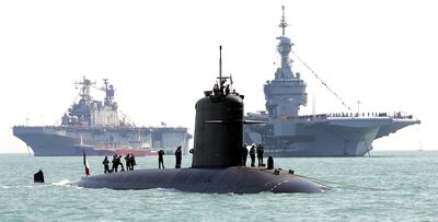 (FILES) In this file photo taken on June 27, 2005 sailors aboard the French submarine "Perle" (C) inspect the vessel in Portsmouth ahead of celebrations.  A fire broke out on June 12, 2020 on board of the 'Perle', one of the French army's six nuclear-powered attack submarines, but without causing any injuries, while it underwent inspections at Toulon naval base.  / AFP / ALESSANDRO ABBONIZIO
