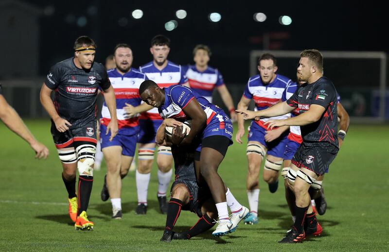 Shingie Maduma of Jebel Ali Dragons is tackled during the match against Dubai Exiles. Pawan Singh / The National   