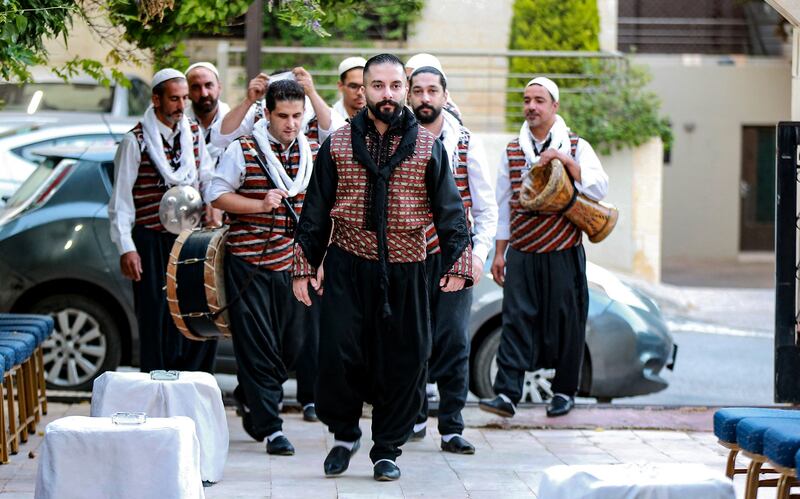 Members of the troupe arrive at a venue for a performance.