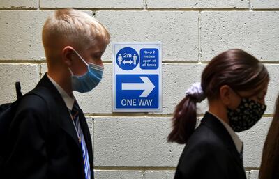 As the Omicron Covid-19 variant spreads in the UK, Prime Minister Boris Johnson's government recommended the wearing of face masks for secondary school pupils in communal areas. AP