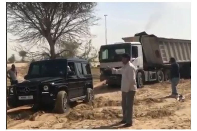 Sheikh Hamdan helps pull a lorry stuck in the desert. Instagram screengrab