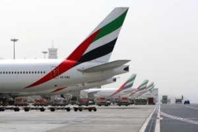 DUBAI, UNITED ARAB EMIRATES - JULY 15:  Emirates planes outside the runway at Terminal 3 of the Dubai International airport in Dubai on July 15, 2009.  (Randi Sokoloff / The National)  For stock--business or travel *** Local Caption ***  RS020-071509-EMIRATES.jpg