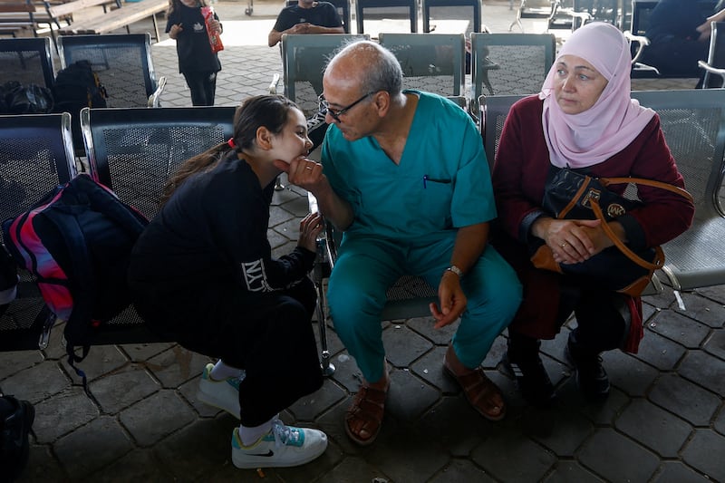 Palestinian doctor Mohammad Abu Namoos, who chose to stay in Gaza to treat patients, says goodbye to his family before they leave. Reuters