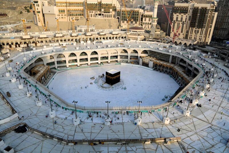 (FILES) This file photo taken on March 05, 2020 shows the white-tiled area surrounding the Kaaba, inside Mecca's Grand Mosque, empty of worshippers.  Saudi Arabia announced it would hold a "very limited" hajj this year owing to the coronavirus pandemic, with pilgrims already in the kingdom allowed to take part. / AFP / ABDEL GHANI BASHIR
