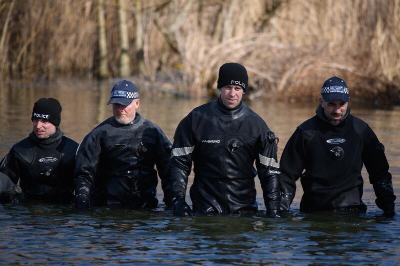 Police search teams work their way through Mount Pond on Clapham Common. Getty Images