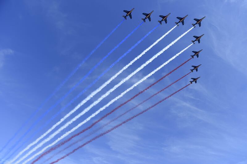 French fighter jets fly over the Champs-Elysees . Saul Loeb  / AFP Photo