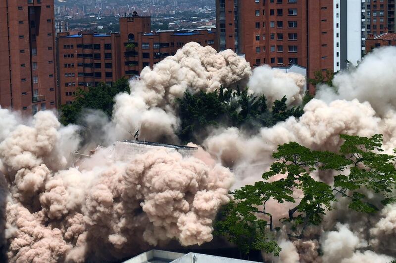 A dust cloud engulfs the area during the demolition of the Monaco building, which was once home to Colombian drug lord Pablo Escobar in Medellin, Colombia.  The site will become a park in memory of the victims of the drug war. AFP