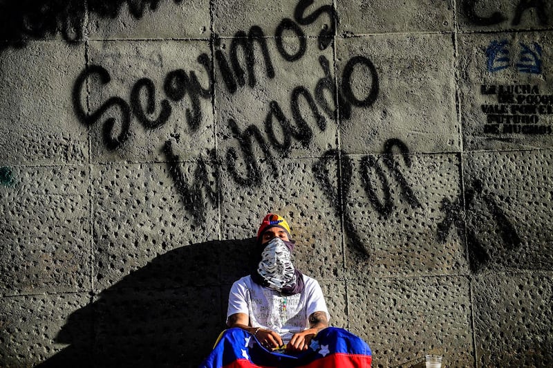 An opposition demonstrator is pictured next to the site where young activist Neomar Lander was mortally wounded during clashes with riot police, during a protest in Caracas, on July 24, 2017
Venezuela's angry opposition is pushing for a boycott of an upcoming vote that it dismisses as a ploy by President Nicolas Maduro to cling to power. / AFP PHOTO / RONALDO SCHEMIDT