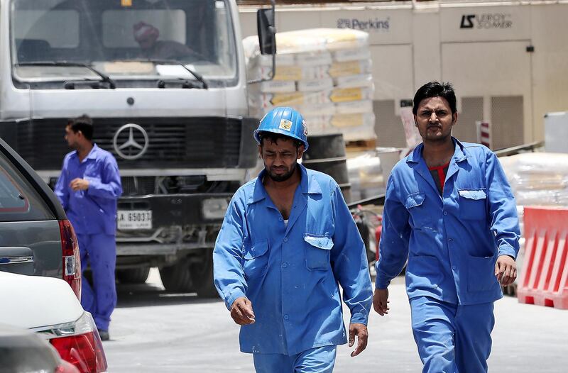 
DUBAI , UNITED ARAB EMIRATES , JUNE 14 – 2018 :- Labourers going to their staff bus after the midday break at one of the construction site in Al Garhoud area in Dubai. ( Pawan Singh / The National )  For News. Story by Ramola
