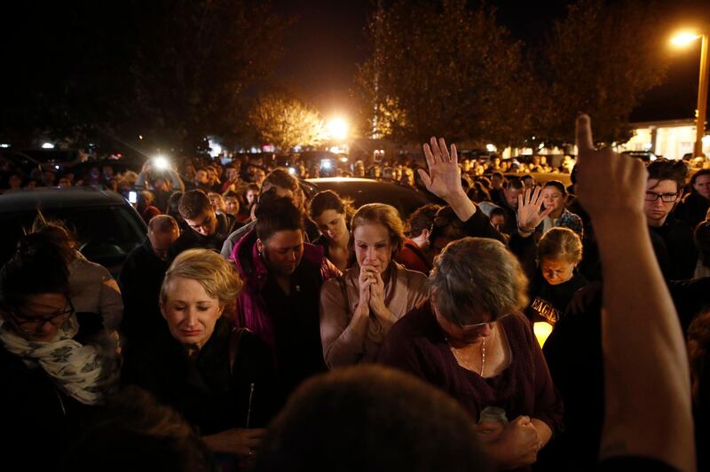 People gather outside the Rivalry Roasters for a vigil for Adler. AP Photo