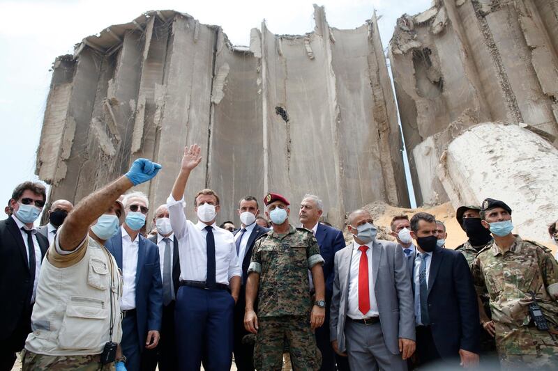 French President Emmanuel Macron gestures as he visits the devastated site of the explosion at the port of Beirut.  EPA