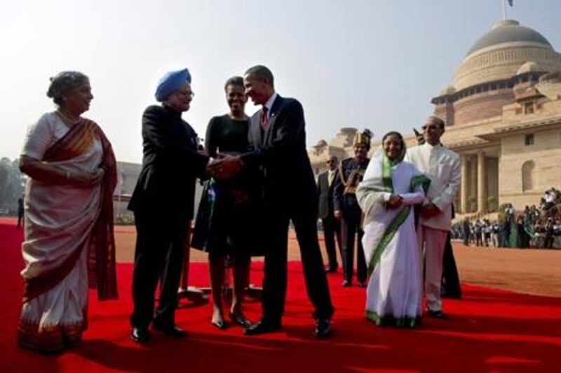 US President Barack Obama shakes hands with Indian Prime Minister Manmohan Singh as his wife Gulcharan Kau (L), First Lady Michele Obama (3R) and President Pratiba Patil (R) look on during a welcoming ceremony at the Presidential palace in New Dehli on November 8, 2010. Obama hailed India as an established "world power" as he received a 21-gun salute at a red carpet state welcome in the capital New Delhi. AFP PHOTO/Pedro UGARTE