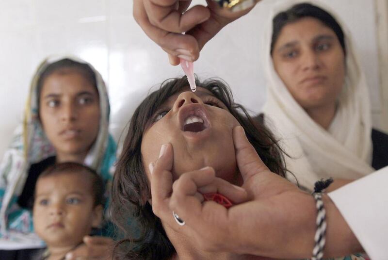 A girl receives polio vaccine drops at a government dispensary in Karachi. (Akhtar Soomro / Reuters)