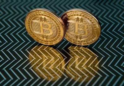 (FILES) In this file photo taken on June 17, 2014 in Washington, DC shows bitcoin medals.  Tesla has invested $1.5 billion in bitcoin, a decision that came just days after the electric carmaker's CEO Elon Musk changed his Twitter bio to simply read "#bitcoin." The announcement, in a US Securities and Exchange Commission document, is a sign of confidence in the cryptocurrency that regulators are concerned could be used for illegal transactions. / AFP / KAREN BLEIER
