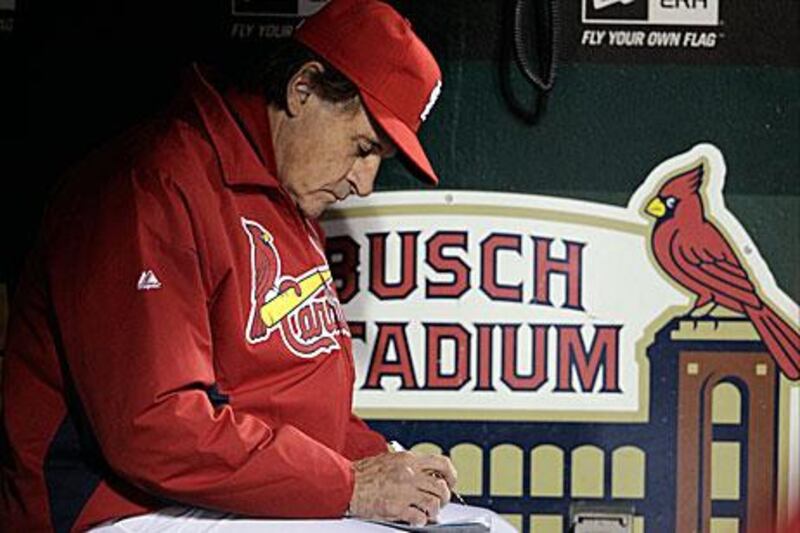 Tony La Russa makes notes in Game 6 of the World Series, as his numerous decisions throughout the post-season crafted St Louis to their 11th World Series.