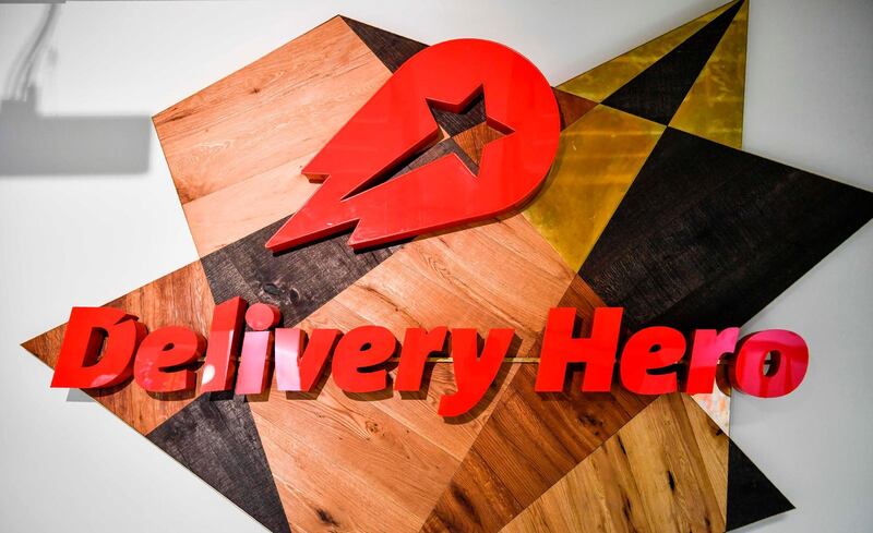 (FILES) This file photo taken on June 27, 2017 shows a logo in a lounge area of the global headquarters of online food ordering and delivery giant Delivery Hero in Berlin. German takeaway giant Delivery Hero on December 13, 2019 said it had agreed to buy South Korea's largest food delivery app Woowa in a 3.6 billion euro ($4 billion) deal aimed at beefing up its presence in Asia. / AFP / John MACDOUGALL
