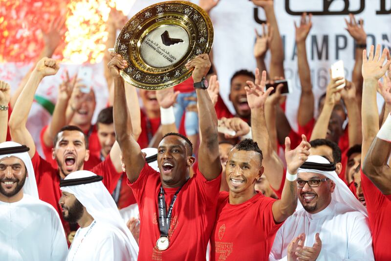 Ahmed Khalil lifts the league trophy with his Al Ahli teammates Ciel (99) after defeating Al Shaab during their final Arabian Gulf League match of the season at Rashid Stadium in Dubai. Christopher Pike / The National