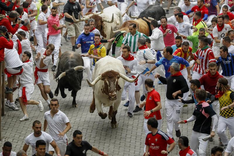 Revellers run with Puerto de San Lorenzo's fighting bulls before entering the bullring during the second day of the San Fermin Running of the Bulls festival in Pamplona, Spain.  Getty Images