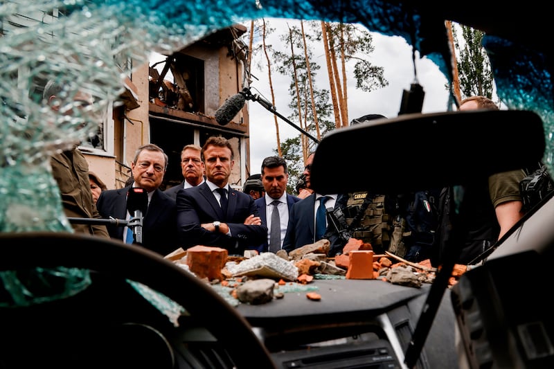Italian Prime Minister Mario Draghi, left, and French President Emmanuel Macron visit Irpin, outside Kyiv, and survey damage following Russia's invasion. AP