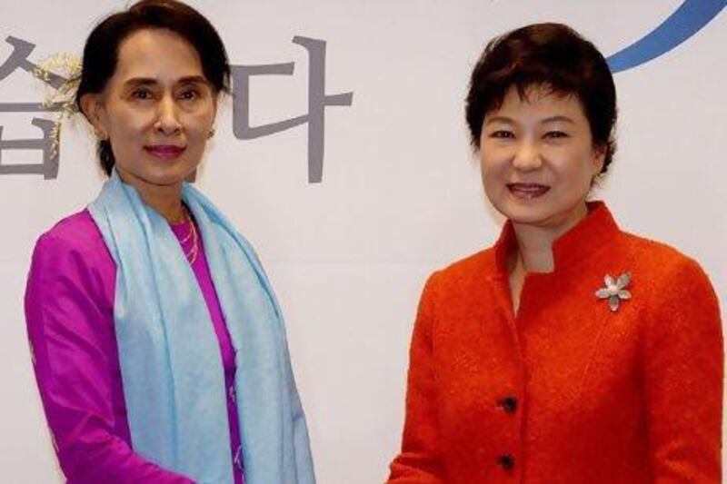 South Korean president-elect Park Geun-hye (right) shakes hands with visiting Myanmar opposition leader Aung San Suu Kyi during a meeting in Seoul.