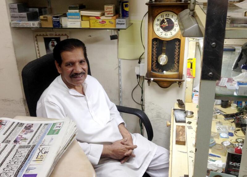Maqsood Ahmed, a clock and watch repairman, sits in his shop in Abu Dhabi’s Al Zahiyah neighbourhood.  John Dennehy / The National



