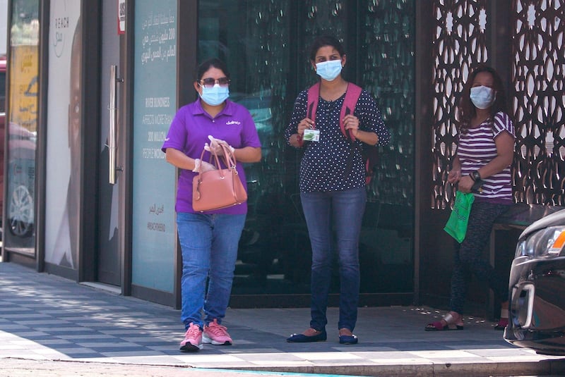 Abu Dhabi, United Arab Emirates, June 3, 2020.   Commuters at a bus stop protect themselves with face masks during the Covid-19 pandemic along Zayed the First Street.Victor Besa  / The NationalSection:  Standalone / Stock