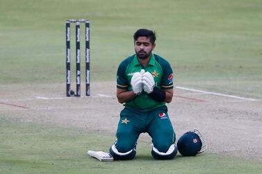 TOPSHOT - Pakistan's captain Babar Azam kneels down while celebrating after scoring a century (100 runs) during the first one-day international (ODI) cricket match between South Africa and Pakistan at SuperSport Park in Centurion on April 2, 2021. / AFP / PHILL MAGAKOE