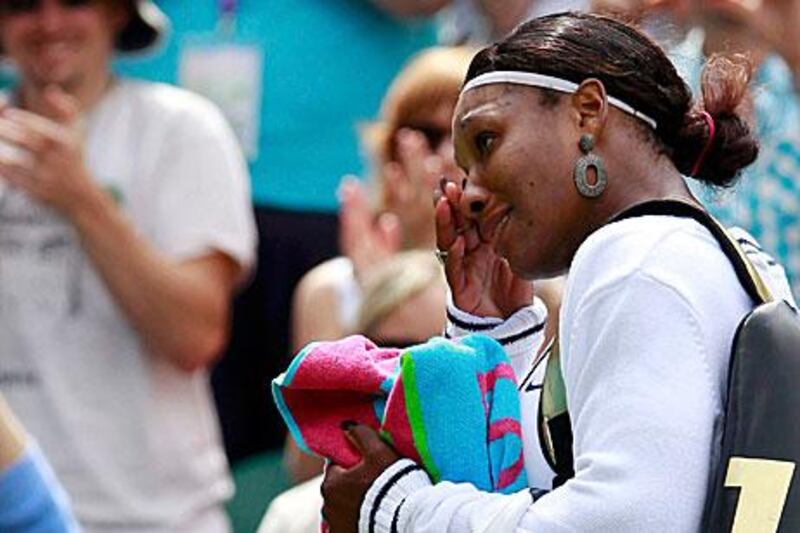 Serena Williams wipes away the tears after her emotional victory over Aravane Rezai yesterday.
