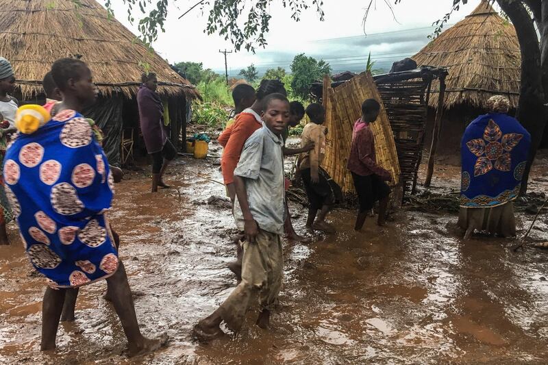 Inhabitants of Chiluvi, a village in central Mozambique, walk along a flooded and muddy street after Cyclone Idai and Floods that hit the region, in Nhamatanda, Mozambique. EPA