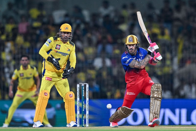 Royal Challengers Bangalore's captain Faf du Plessis plays a shot as Chennai Super Kings' MS Dhoni watches on. AFP