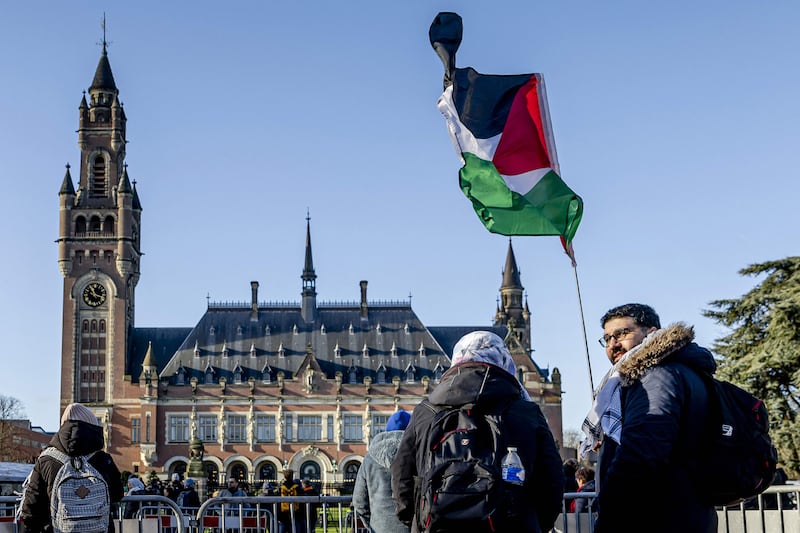 A demonstrator waves the Palestinian flag in front of the Peace Palace, which houses the International Court of Justice, in The Hague. AFP