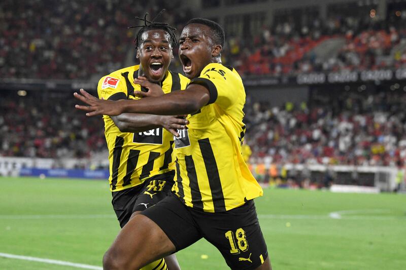 Borussia Dortmund footballers Jamie Bynoe-Gittens, left, and Youssoufa Moukoko celebrate their 3-2 victory against SC Freiburg, in Freiburg im Breisgau, south-western Germany. AFP