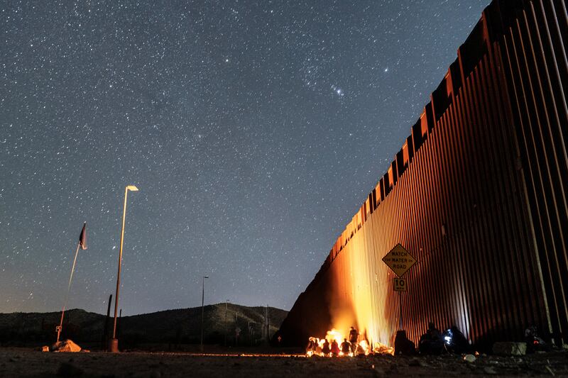 Migrants wait to be transported by the US border patrol after crossing the border into the US from Mexico. The number of migrants has surged in the border town of Lukeville, Arizona. Reuters