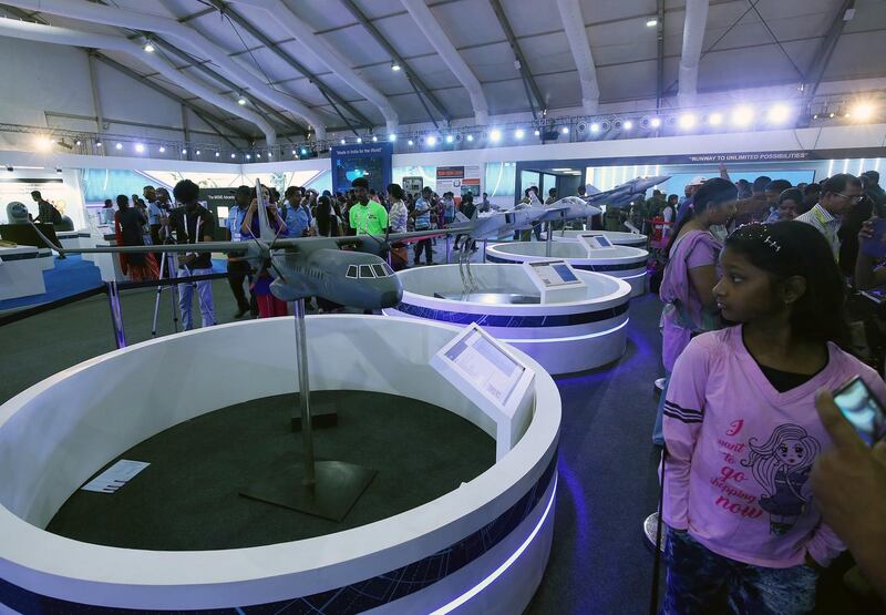 epa07392137 Visitors look at a model of an Airbus C295 on display during the final day of the Aero India 2019 at the Yelahanka Air Force Station in Bangalore, India, 24 February 2019.The event runs from 20 to 24 February 2019  EPA/JAGADEESH NV