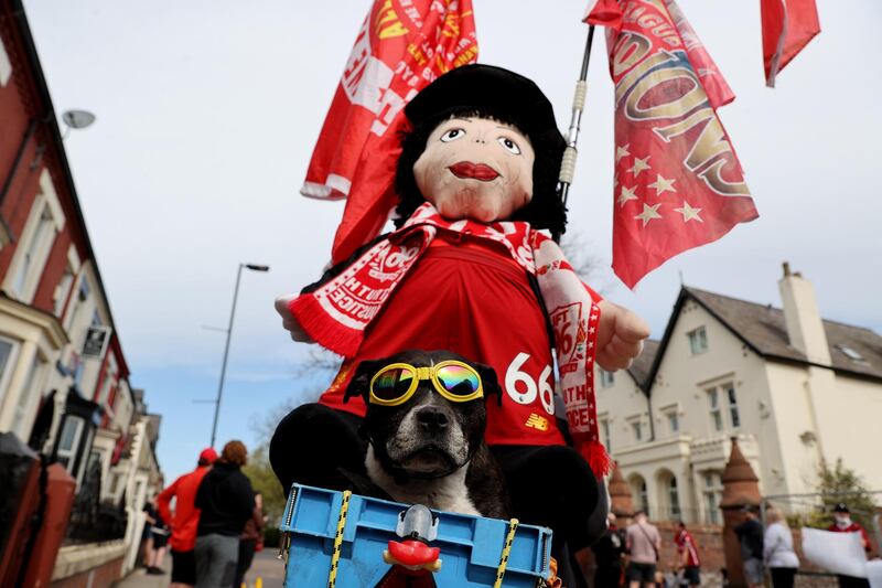A dog joins the Liverpool the protest. Reuters
