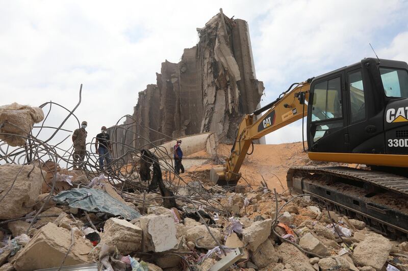 An excavator cleans debris near the damaged grain silo at the site of Tuesday's blast, at Beirut's port area, Lebanon. Reuters