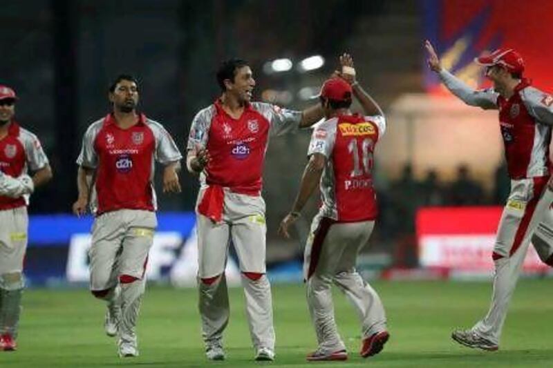Kings XI Punjab's Azhar Mahmood, second left, took three wickets in the win over the Royal Challengers Bangalore.