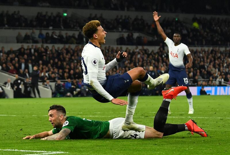 Brighton's Shane Duffy, left, tackles Tottenham's Dele Alli. Reuters