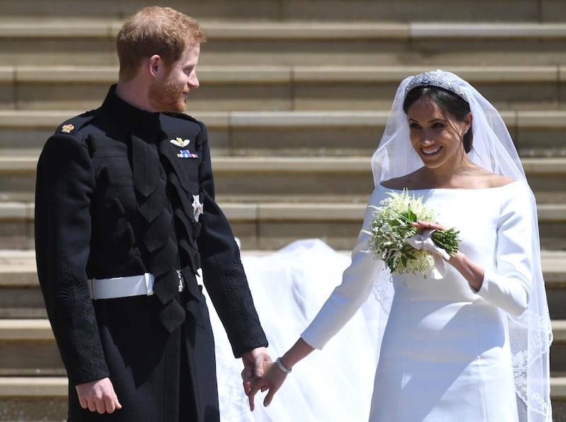 epa06749781 Britain's Prince Harry (L), Duke of Sussex and Meghan (R), Duchess of Sussex exit St George's Chapel in Windsor Castle after their royal wedding ceremony, in Windsor, Britain, 19 May 2018. The couple have been bestowed the royal titles of Duke and Duchess of Sussex on them by the British monarch.  EPA/NEIL HALL / POOL