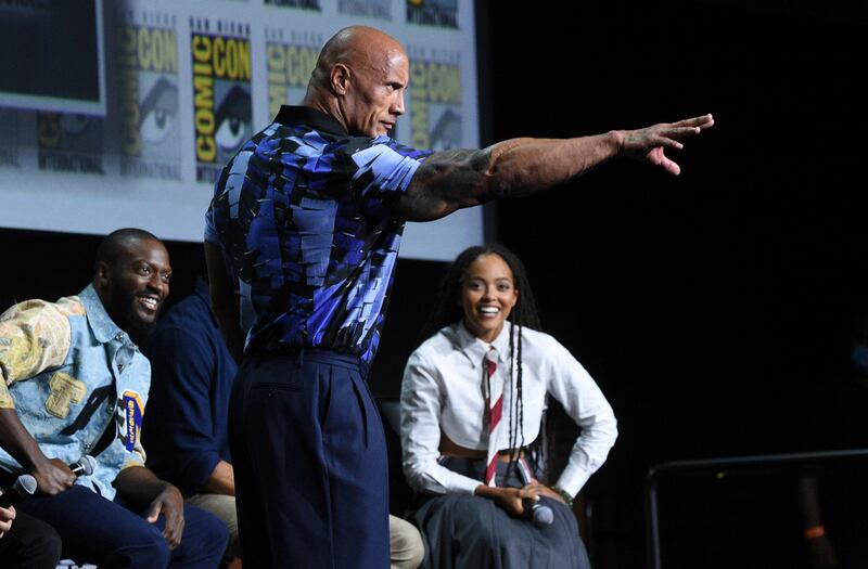 From left, Aldis Hodge, Dwayne 'The Rock' Johnson and Quintessa Swindell participate in the Black Adam portion of the Warner Bros Theatrical panel on day three of the San Diego Comic-Con International. AP