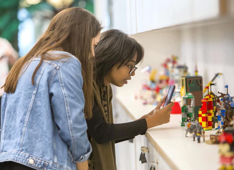 DUBAI, UNITED ARAB EMIRATES - Visitors taking snaps of the Lego toys at the opening of the new Lego office in Dubai Design District.  Leslie Pableo for The National
