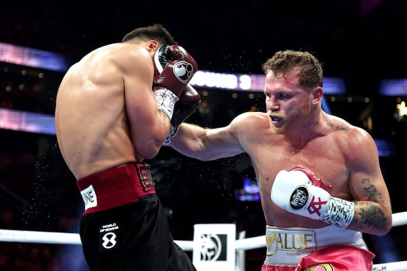 Canelo Alvarez punches Dmitry Bivol during their WBA light heavyweight title fight at T-Mobile Arena.