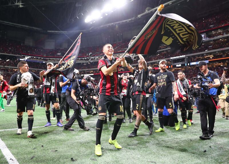 Atlanta United's Miguel Almiron waves a flag after defeating the Portland Timbers. Reuters