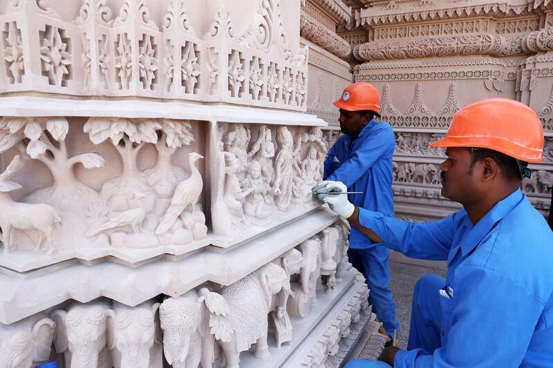 Workers making the final touches to the carvings. Pawan Singh / The National