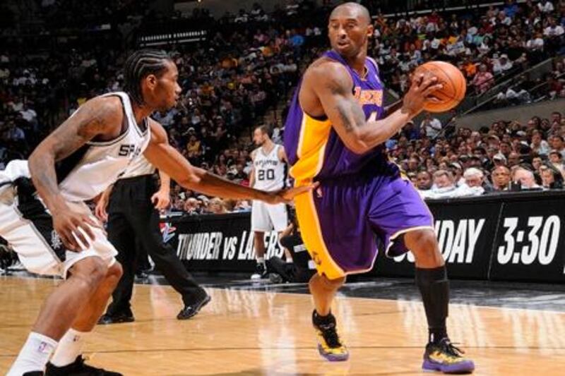 SAN ANTONIO, TX - APRIL 20: Kobe Bryant #24 of the Los Angeles Lakers moves the ball against Kawhi Leonard #2 of the San Antonio Spurs on April 20, 2012 at the AT&T Center in San Antonio, Texas. NOTE TO USER: User expressly acknowledges and agrees that, by downloading and or using this photograph, user is consenting to the terms and conditions of the Getty Images License Agreement. Mandatory Copyright Notice: Copyright 2012 NBAE (Photos by D. Clarke Evans/NBAE via Getty Images/AFP