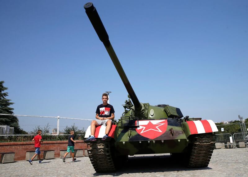 A boy sits on a former Yugoslav army T-55 battle tank in front of the northern stand of the Rajko Mitic stadium in Belgrade. EPA