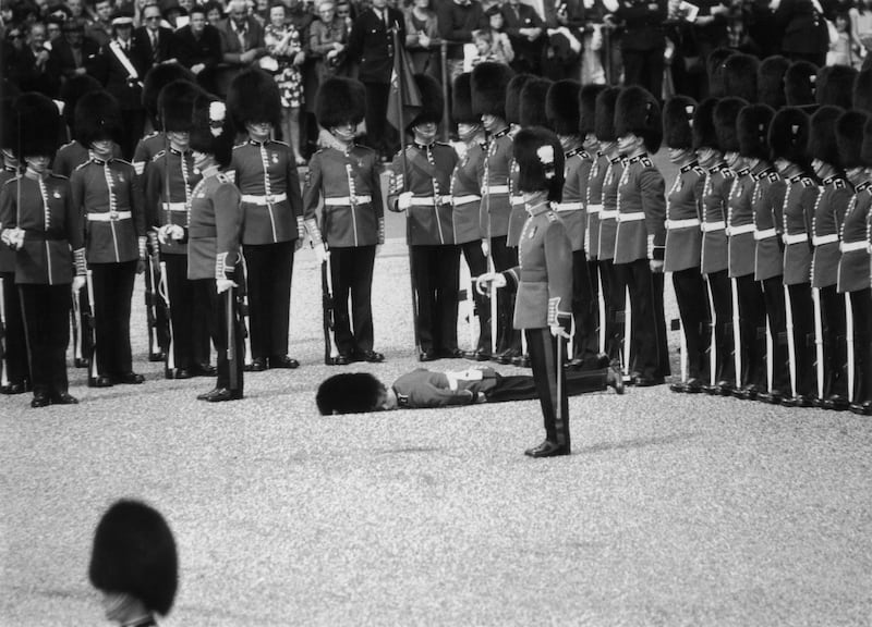 A guardsman collapses during a rehearsal of the Trooping of Colour in 1974