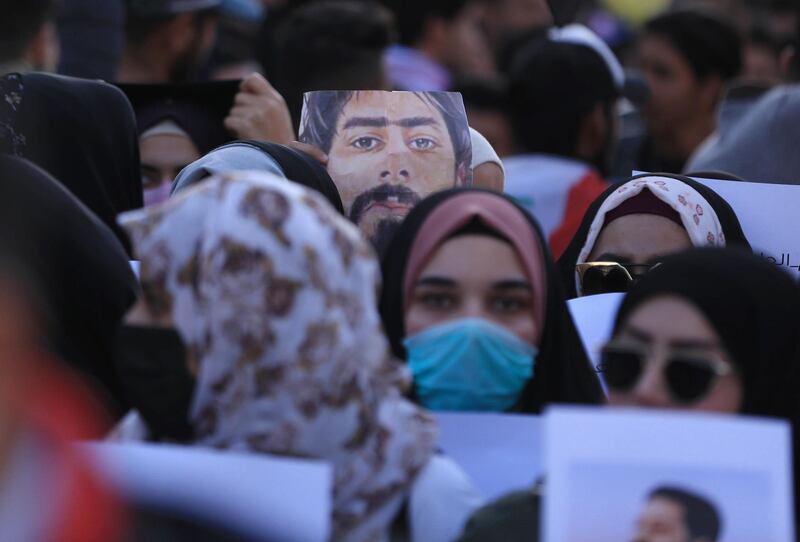 Iraqi demonstrators hold up a portrait of late fellow protester Safaa Saray, killed during the past three months of anti-government protests, as thousands took to the streets on January 10, 2020 in the Shiite holy city of Karbala in central Iraq and other cities across the country,  reviving the opposition movement against the authorities and adding criticisms of both the US and Iran to their chants. The anti-regime rallies had been overshadowed recently by spiralling tensions between Tehran and Washington, which led each country to carry out strikes against the other's assets in Iraq over the last week. / AFP / Mohammed SAWAF
